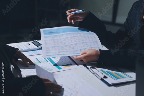 Obraz Group of business women working on a financial data expenses document.