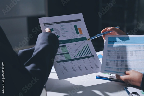 Obraz Group of business women working on a financial data expenses document.