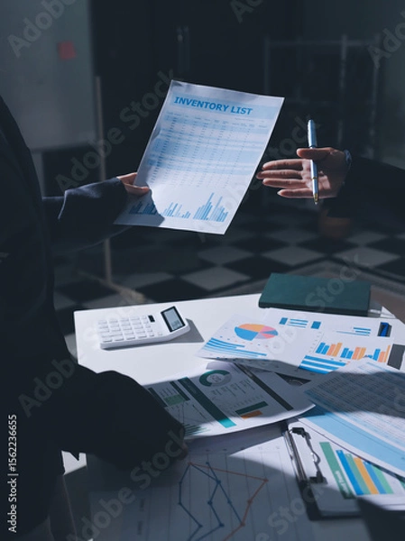 Obraz Group of business women working on a financial data expenses document.