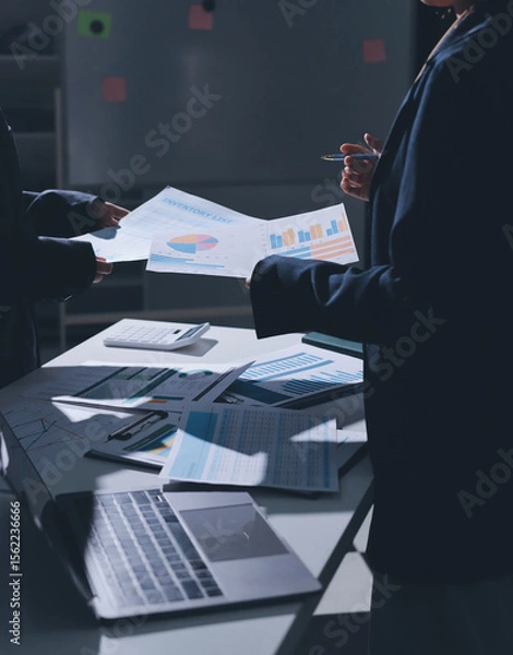 Obraz Group of business women working on a financial data expenses document.