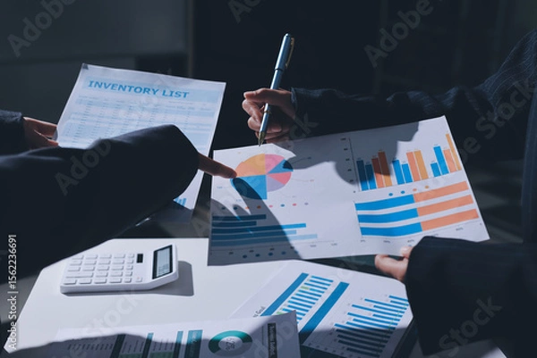 Obraz Group of business women working on a financial data expenses document.