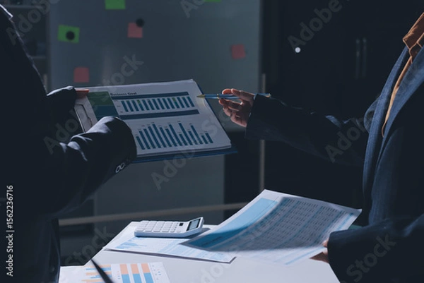 Obraz Group of business women working on a financial data expenses document.