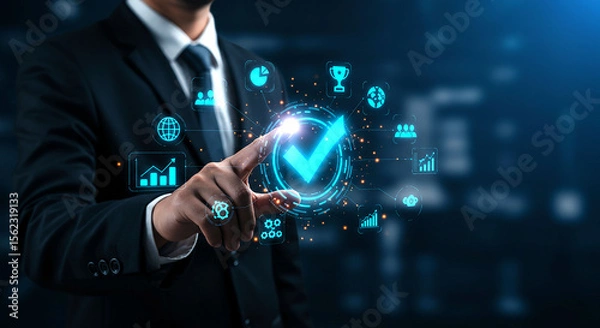 Fototapeta Businessman pointing at a glowing checkmark surrounded by data icons in a digital interface