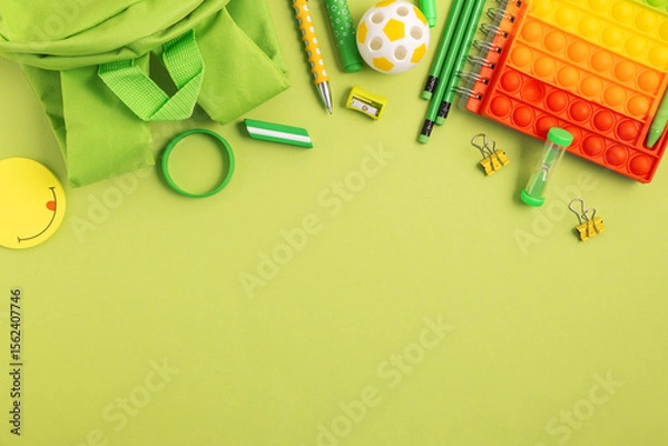Obraz Back to school concept. Border made of school supplies on green background. Top view. Copy space