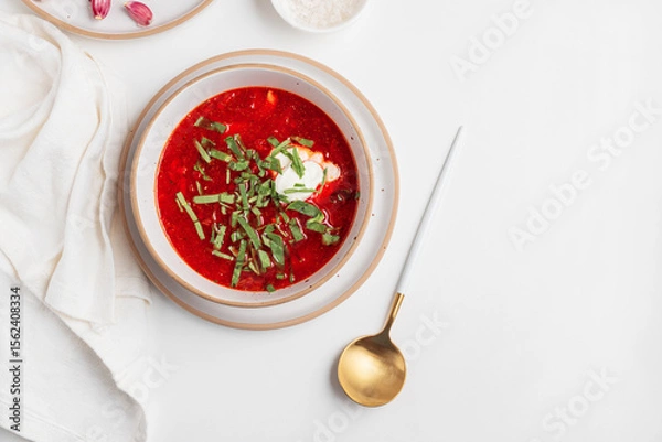 Obraz Traditional Ukrainian borscht with sour cream, garlic and rye bread on white table. Top view