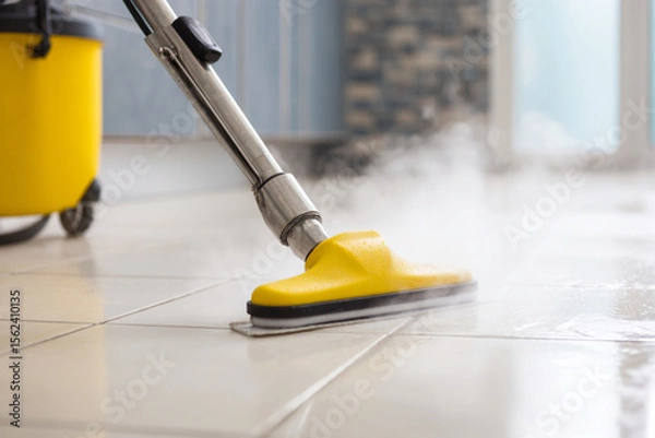 Fototapeta Steam cleaning tile floors in a modern kitchen during daylight hours for deep sanitization and shine