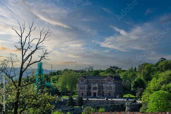 Fototapeta Sunset Glow on an Elegant Historical Building in Comillas
