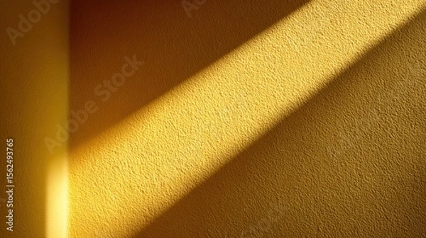 Fototapeta Bright afternoon sunlight casts soft shadows on a textured yellow wall, creating a warm and inviting atmosphere