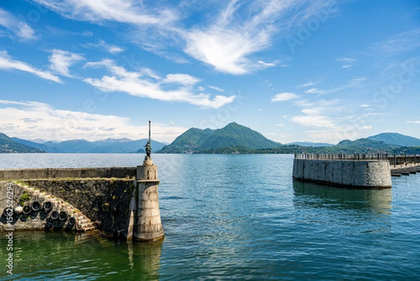 Obraz Enjoy the breathtaking view of a lake surrounded by majestic mountains and clear blue sky