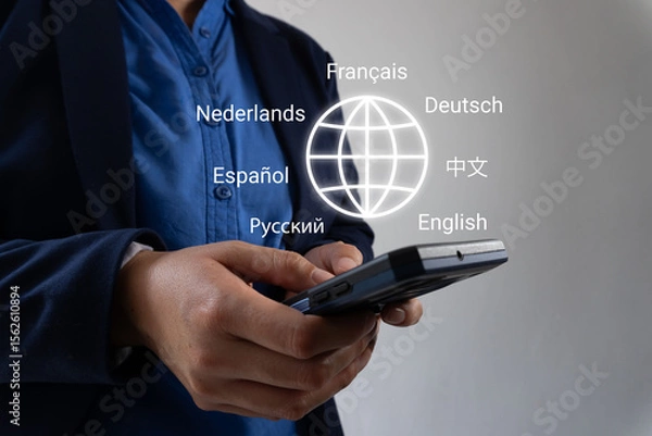 Fototapeta Businessman hands holding smartphone with globe icon and various languages ​​around, language translator concept