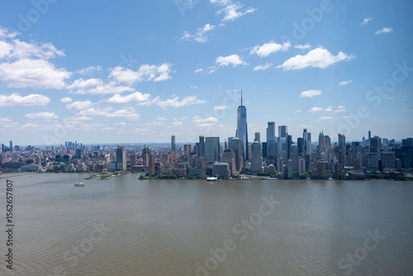 Fototapeta Stunning East River view of New York City skyline and iconic bridges on clear day