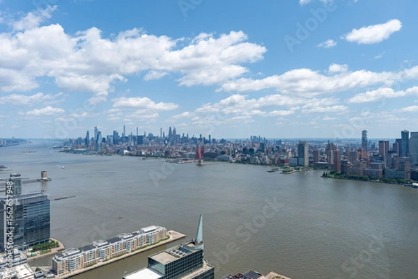 Fototapeta Stunning East River view of New York City skyline and iconic bridges on clear day
