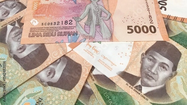 Fototapeta Indonesian money, close up five thousand rupiah,5000 banknotes scattered 