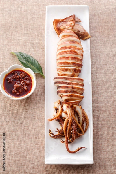 Fototapeta Japanese squid grilled on a plate with exquisite tableware