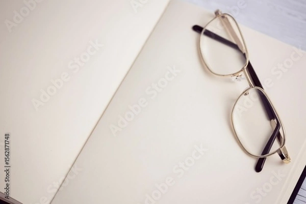 Obraz Metallic eyeglasses on wooden table