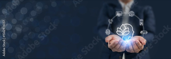 Obraz Digital Wellbeing and Detox Concep. Holding a glowing digital interface with icons representing mental wellness on blue background. Balance between staying connected and practicing digital detox.
