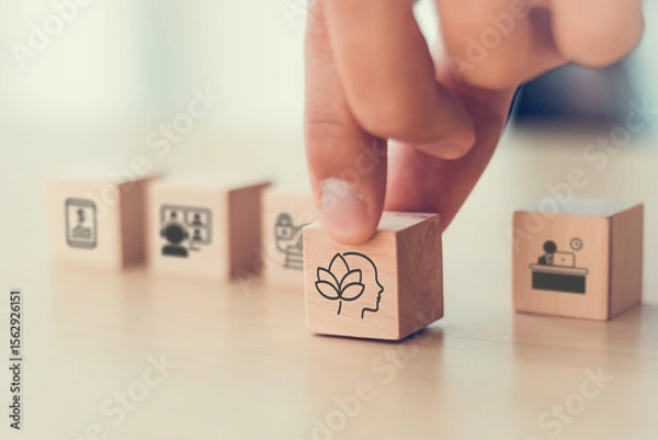 Obraz Digital wellbeing in workplace concept. Wooden blocks with icons representing digital wellbeing, healthy work-life balance. Promoting a healthy relationship with technology, encouraging mindful usage.