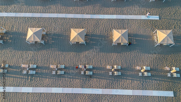 Obraz Sun umbrellas and sun loungers on the beach, Tyrrhenian Sea, tourist resort of Viareggio, Italy. View from above