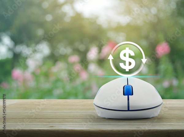 Fototapeta Money transfer icon on wireless computer mouse on wooden table over blur pink flower and tree in garden, Business currency exchange online service concept