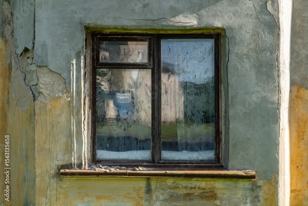 Fototapeta Old Weathered Window with Peeling Paint and Cracked Wall in Rustic Countryside Building