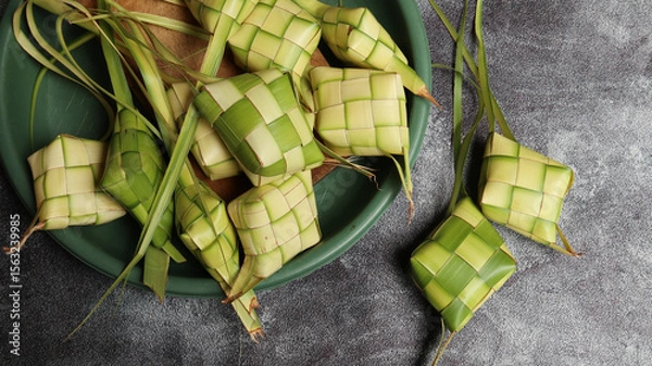 Obraz Ketupat (Rice Dumpling) On White Background. Ketupat is a natural rice casing made from young coconut leaves for cooking rice during eid Mubarak, Eid Fitr. top view