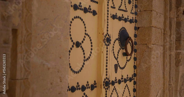 Fototapeta Close up architectural door in old ancient city of Sousse. Colorful textured door of muslim architecture.