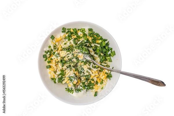Fototapeta salad of boiled eggs and green onions chopped and seasoned with cream sauce, diet, top view, isolate