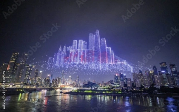 Obraz Illuminated drone skyline show above modern city at night with reflection on water below