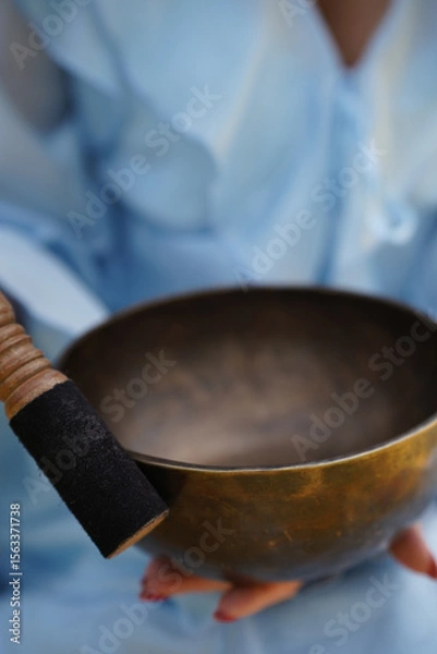 Fototapeta Metallic bowl used for meditation and sound therapy. Image suitable for wellness, relaxation, and mindfulness concepts.