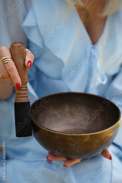 Fototapeta Metallic bowl used for meditation and sound therapy. Image suitable for wellness, relaxation, and mindfulness concepts.