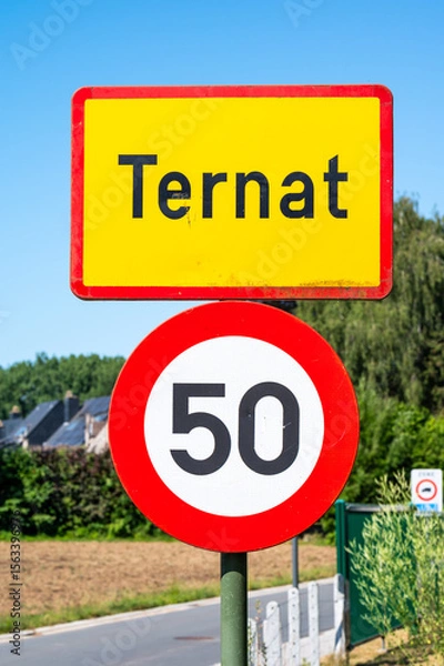 Fototapeta Traffic sign of Ternat, an urbanisation with a maximum speed limit of 50, Ternat, Flanders, Belgium