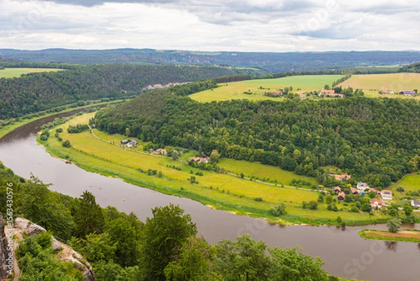 Obraz Königstein, Germany – June 5, 2025: Scenic view from the historic fortress Königstein overlooking lush forests and distant hills in Saxon Switzerland under a dramatic cloudy sky