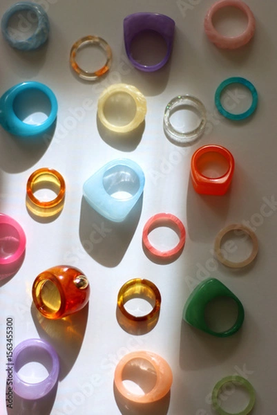Obraz Collection of colorful plastic rings on white background. Top view.