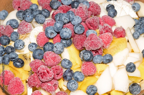 Obraz fresh blueberries, kiwi, apples, mango and frostet raspberries