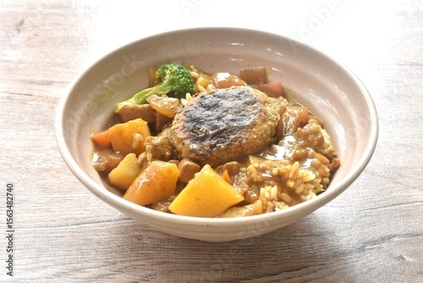 Obraz hamburg crispy fried chop pork with boiled vegetable topping plain rice dressing potato and carrot in Japanese curry on bowl