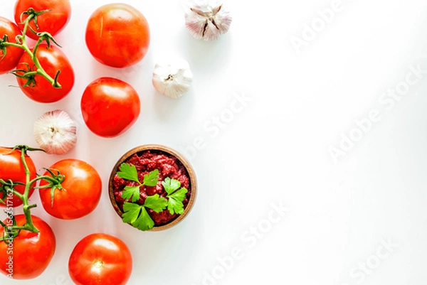 Obraz Tomato frame with suase and garlic on white background top-down copy space