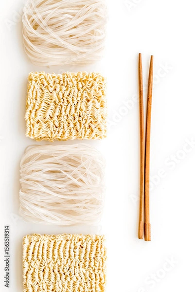 Obraz Rice vermicelli, noodles, sticks to cook Chinese and Japanese food design on white background top view