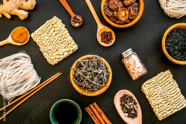 Obraz Chinese and Japanese food cooking with ginger, spices and noodles on black background top view geometric pattern