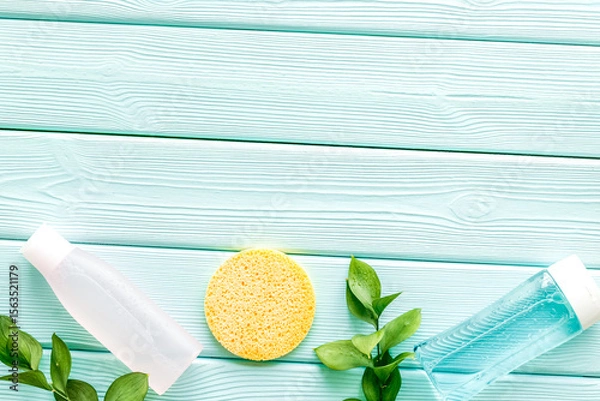 Obraz skin care cosmetics with facial tonic, mycelial water and sponge on mint greem background top view mockup