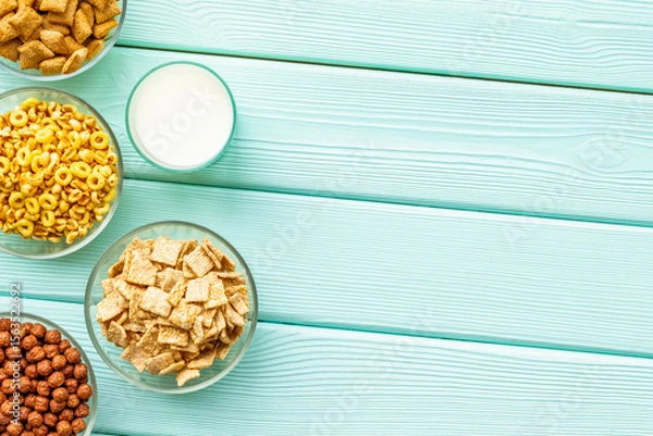 Obraz Cereals and flakes from corn and oat on mint wooden background top view mockup