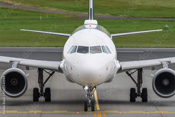 Fototapeta Commercial Airplane Preparing for Takeoff or Taxing on Runway During Daytime