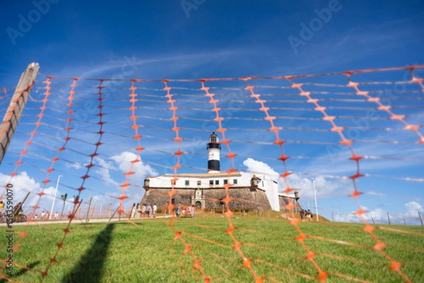 Fototapeta Low view through the red ribbons of the Barra Lighthouse, a postcard of the city of Salvador, Brazil.