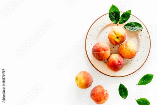 Obraz Summer fruits. Ripe red peaches on plate on white table top-down copy space