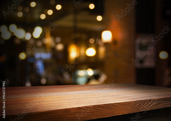 Fototapeta Empty wooden table with bokeh and blur restaurant background, for your photo montage or product display, Space for placing items on the table, product and food display.	