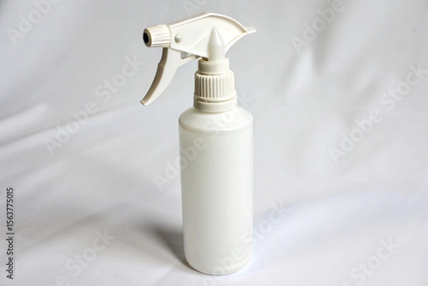 Fototapeta Minimalist unbranded white plastic spray bottle with a trigger, on a seamless white background.