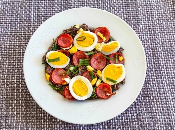 Fototapeta Traditional black bean tutu with kale, calabrese sausage, bacon and egg. A classic rustic dish from Minas Gerais