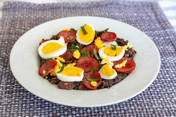 Fototapeta Traditional black bean tutu with kale, calabrese sausage, bacon and egg. A classic rustic dish from Minas Gerais
