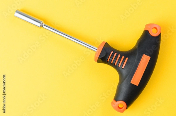 Fototapeta Holder for hex socket bits on bright yellow background metal tool set top view