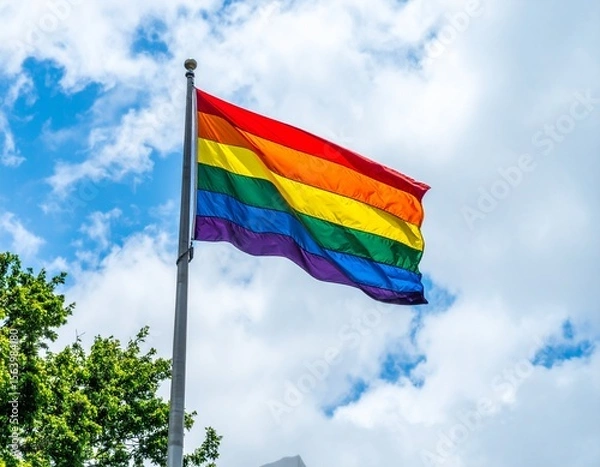 Fototapeta GLBTQ rainbow flag waving on its flagpole AI generated