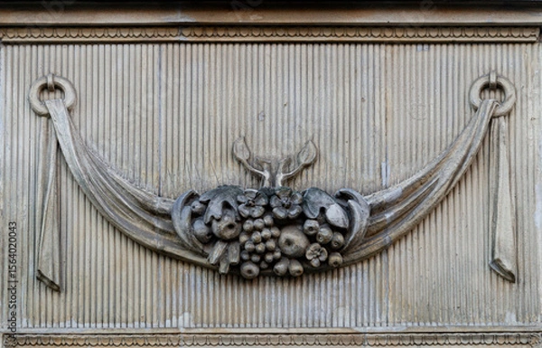 Obraz Stone wall with carved floral pattern	